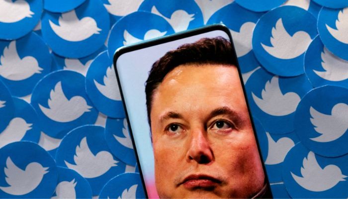 An image of Elon Musk is seen on smartphone placed on printed Twitter logos in this picture illustration taken April 28, 2022.— Reuters