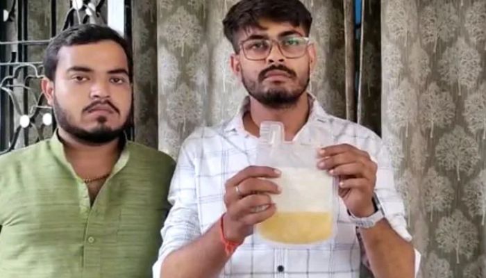 A man holds a transfusion packet containing fruit juice.— NDTV