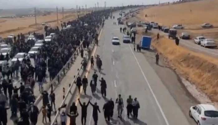 People march down the highway toward the Aychi Cemetery, where Mahsa Amini is buried, near Saqez, Iran, in this screengrab taken from a social media video released October 26, 2022. — Reuters/File