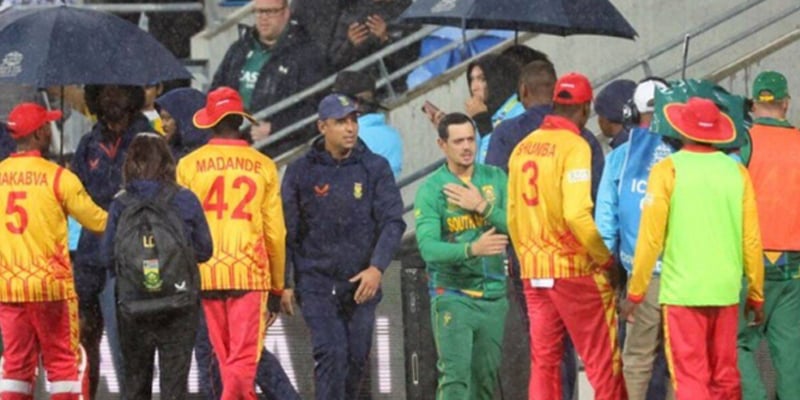 South Africa and Zimbabwe cricketers shake hands after the match was washed out due to rain. — AFP