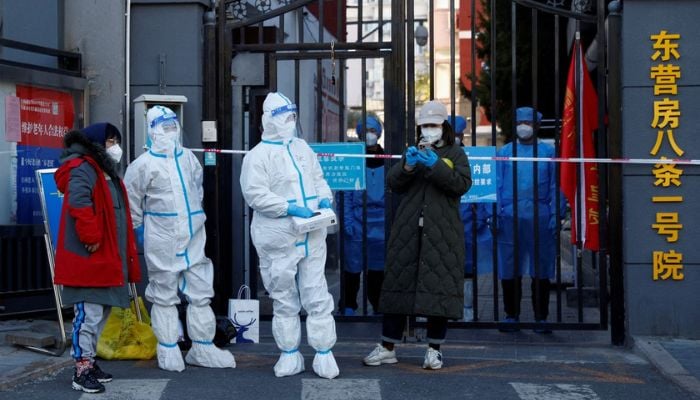 Security personnel in protective suits stand at the gate of a residential compound that is under lockdown as outbreaks of coronavirus disease (COVID-19) continue in Beijing, October 22, 2022.— Reuters