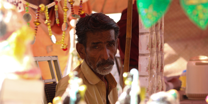 Arjun poses for a photograph while seated at his stall. — Photo by author