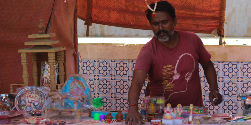 Ashok, the vendor selling Diwali items, stands at his awaiting customers. — Photo by author