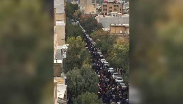 This image grab from a UGC video posted on October 27, 2022, shows protesters marching on a street in Iran´s Kurdish city of Mahabad as demonstrations re-erupt a day after a protester was killed in a rally commemorating the 40th day since Mahsa Aminis death. — AFP/File