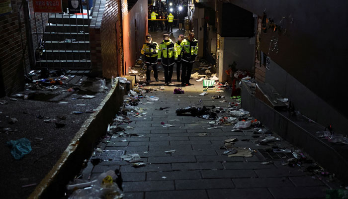 Police officers walk at the scene where many people died and were injured in a stampede during a Halloween festival in Seoul, South Korea, October 30, 2022. — Reuters