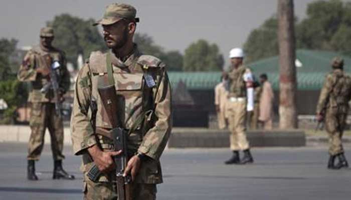 Armed soldiers stand guard outside Pakistans army headquarters in Rawalpindi October 11, 2009. — Reuters/File