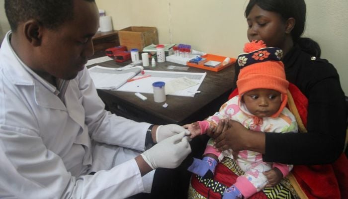 A doctor tests a child for malaria at the Ithani-Asheri Hospital in Arusha, Tanzania, file.— Reuters