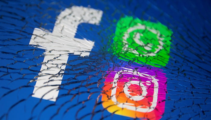 Facebook, Whatsapp and Instagram logos are displayed through broken glass in this illustration taken October 4, 2021. — Reuters