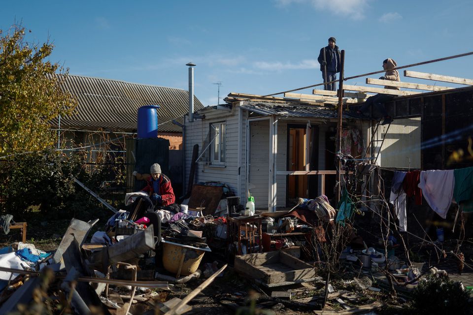 Local resident Iryna sorts home items at a site of her family house, destroyed during a recent Russian military attack in the town of Nikopol, Dnipropetrovsk region, Ukraine November 7, 2022. Reuters