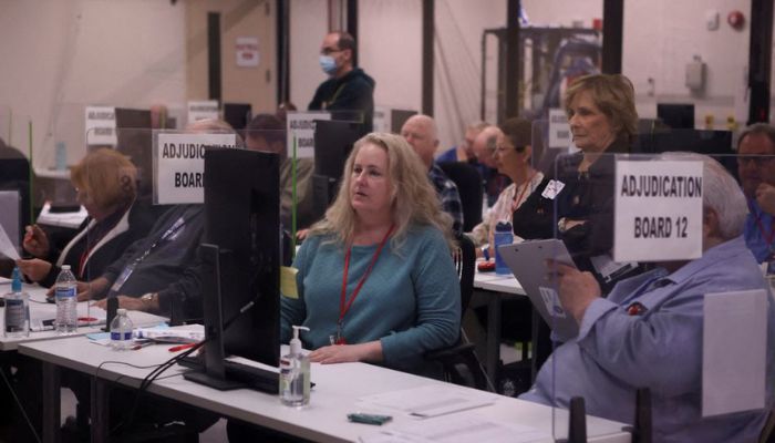 Staff adjudicate ballots for the U.S. midterm elections at the Maricopa County Tabulation and Election Center in Phoenix, Arizona, U.S., November 9, 2022.— Reuters