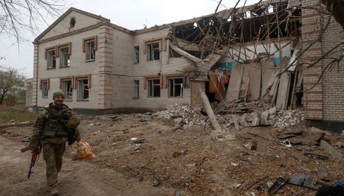 A Ukrainian serviceman walks past a building of a kindergarten damaged during a Russian missile attack in the village of Novooleksandrivka, in Kherson region, Ukraine November 9, 2022.— Reuters