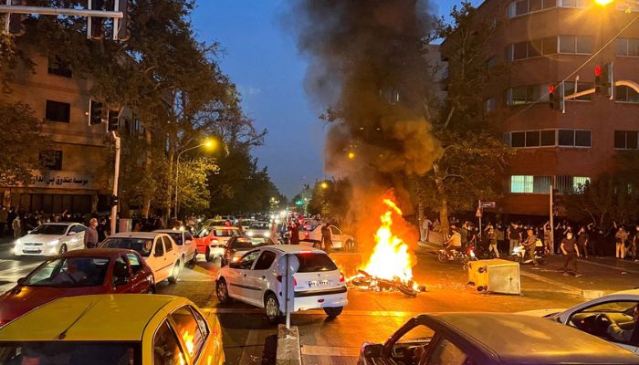 A police motorcycle burns during a protest over the death of Mahsa Amini, a woman who died after being arrested by the Islamic republics morality police, in Tehran, Iran September 19, 2022.— Reuters