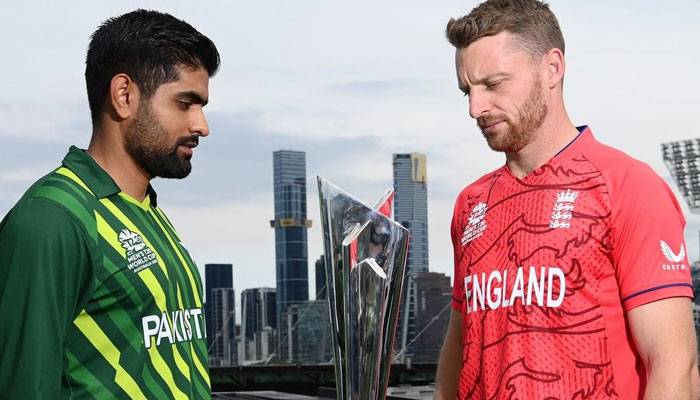 Pakistan's captain Babar Azam (L) and England's skipper Jos Buttler eye the T20 World Cup trophy on the eve of the final match scheduled to be played on November 13, 2022. —
