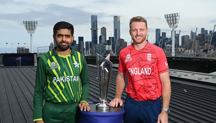 Pakistans captain Babar Azam (L) and Englands skipper Jos Buttler eye the T20 World Cup trophy on the eve of the final match scheduled to be played on November 13, 2022. — ICC