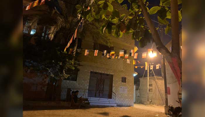 Flags lined up above the street in Malir with flags of football teams in the FIFA World Cup. — Photo by author