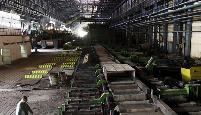 A man walks past machines at the hot strip mill department of the Pakistan Steel Mills (PSM) on the outskirts of Karachi Feb 8, 2016. —Reuters