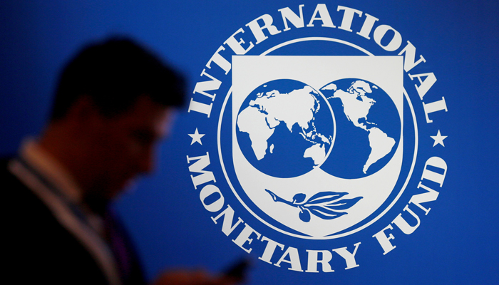 A participant stands near a logo of IMF at the International Monetary Fund - World Bank Annual Meeting 2018 in Nusa Dua, Bali, Indonesia, October 12, 2018. — Reuters