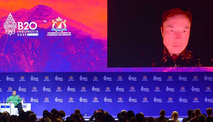 Tesla CEO and Twitter owner Elon Musk (R) speaks virtually with Anindya Bakrie (L), Chairman of Supervisory Board of Indonesian Chamber of Commerce and Industry, at the B20 Summit as part of the G20 dialogue in Nusa Dua on the Indonesian resort island of Bali on November 14, 2022. — AFP