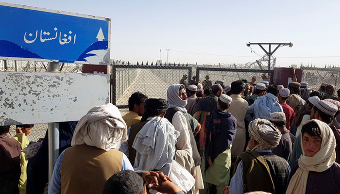 People gather as they wait to cross at the Friendship Gate crossing point in the Pakistan-Afghanistan border town of Chaman, Pakistan August 12, 2021. — Reuters