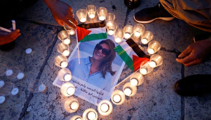 People light candles during a vigil in memory of Al Jazeera journalist Shireen Abu Akleh, who was killed during an Israeli raid, outside the Church of the Nativity in Bethlehem, in the Israeli-occupied West Bank, May 16, 2022.— Reuters