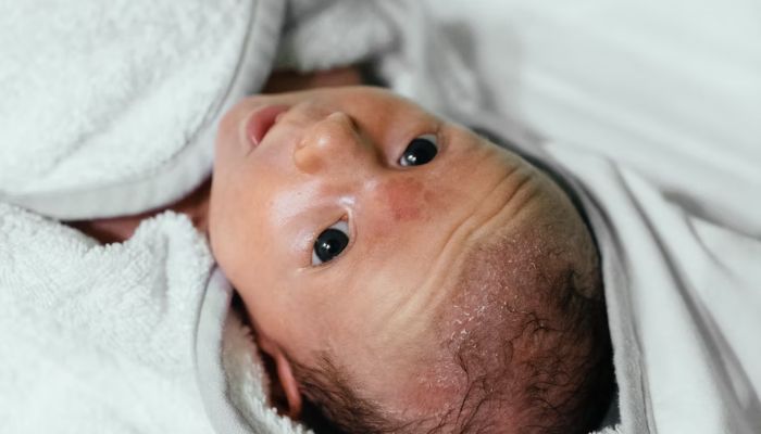 A baby cooing and looking at the ceiling.— Unsplash