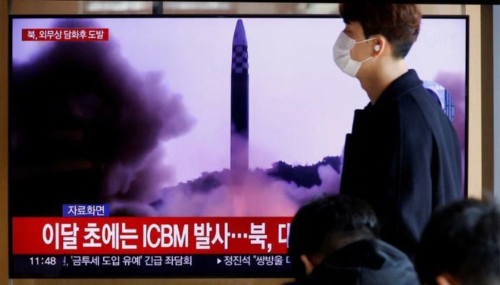 A man walks past a TV broadcasting a news report, on North Korea firing a ballistic missile off its east coast, in Seoul, South Korea, November 17, 2022.— Reuters