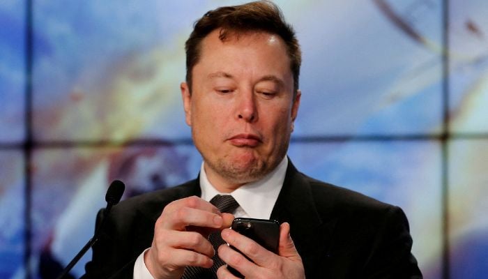 Elon Musk looks at his mobile phone in Cape Canaveral, Florida, U.S. January 19, 2020.— Reuters