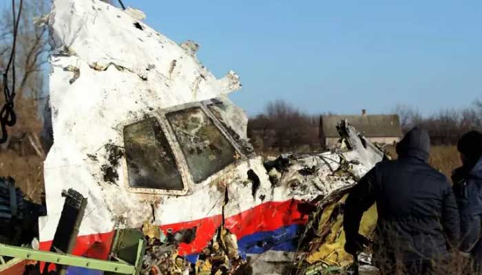 In this image from November 2014, local workers transport a piece of wreckage from Malaysia Airlines flight MH17 at the site of the plane crash near the village of Hrabove (Grabovo) in Donetsk region, eastern Ukraine. — Reuters