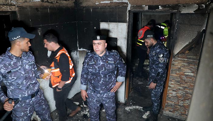 Palestinian Hamas police officers check the scene of a fire that broke out in a building where residents attended a party in the northern Gaza Strip November 17, 2022. — Reuters