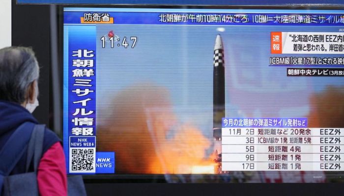 A passerby looks at a television screen showing a news report about North Korea firing a ballistic missile in Tokyo, Japan November 18, 2022.— Reuters