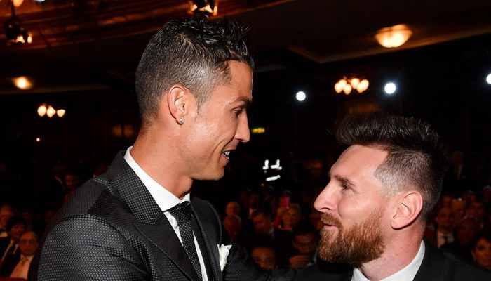 Lionel Messi (R) and Cristiano Ronaldo (L) chat before taking their seats for The Best FIFA Football Awards ceremony. —AFP/File