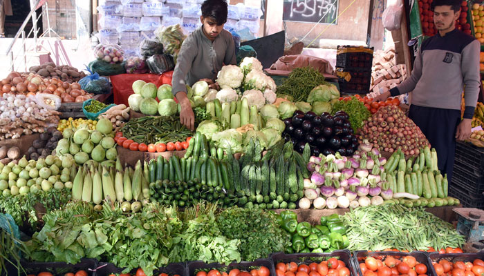 A vendor is displaying vegetable attractions for customers for selling purposes at his workplace in Islamabad. — Online/AFP