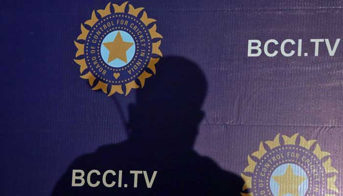 The shadow of a man falls on a backdrop with the logo of the Indias cricket board BCCI before the start of a news conference to announce its cricket teams coach, in Mumbai, India, August 16, 2019. — Reuters