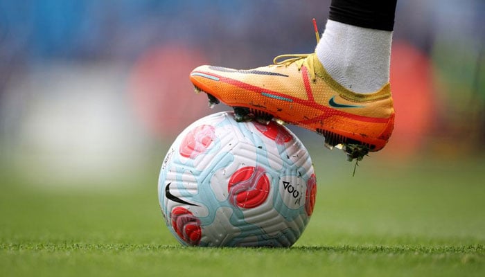 Photo shows a soccer player standing in a green field with a foot on the football.. — Reuters/File