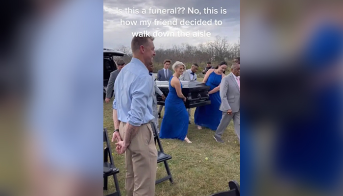 The picture shows wedding attendees carrying groom inside the coffin. — TikTok/Screengrab