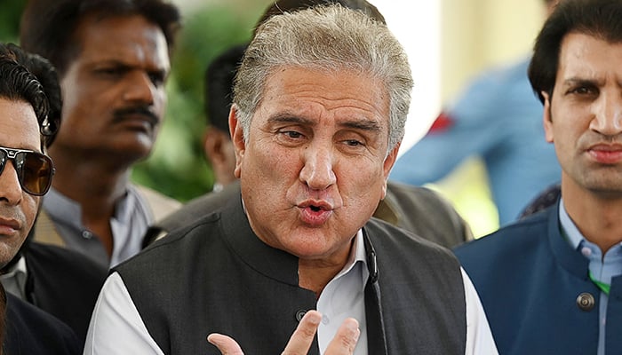 PTI Vice Chairman Shah Mahmood Qureshi speaks with the media before attending a hearing outside the Supreme Court building in Islamabad on April 7, 2022. — AFP