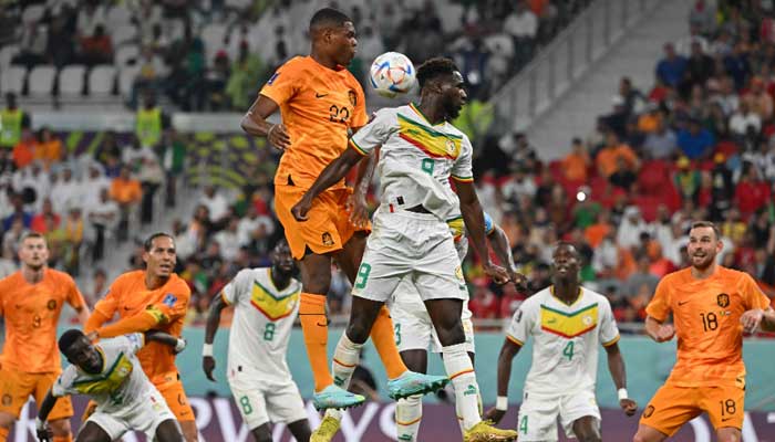 Netherlands´ defender Denzel Dumfries (L) and Senegal’s forward Boulaye Dia jump for the ball during the Qatar 2022 World Cup Group A football match between Senegal and the Netherlands at the Al-Thumama Stadium in Doha on November 21, 2022. —AFP