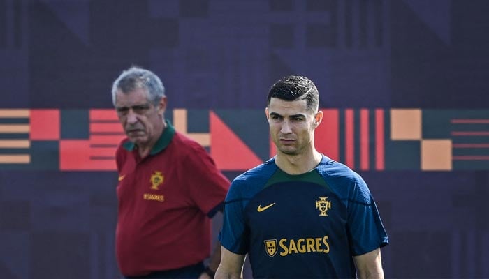 Portugal´s forward Cristiano Ronaldo (R) takes part in a training session as coach Fernando Santos looks on at Shahaniya Sports Club in Al Samriya, northwest of Doha on November 20, 2022. — AFP