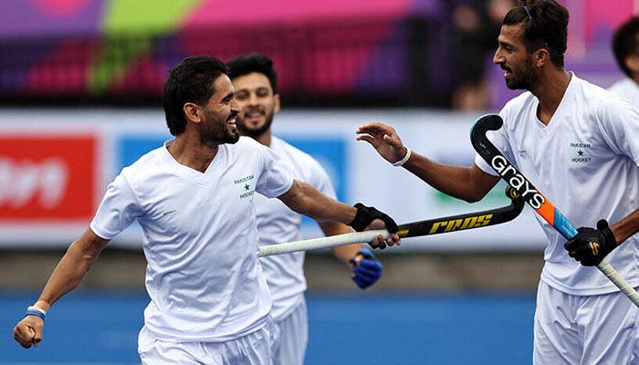 Pakistani hockey players rejoice after smashing a goal in this undated photo. — Reuters/File