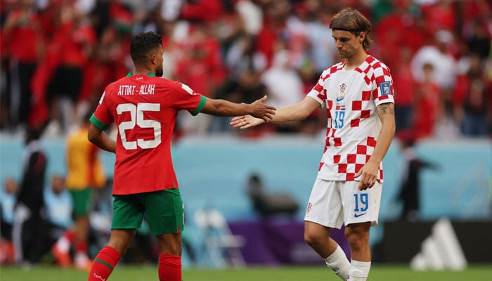 Moroccos Yahya Attiat-Allah shakes hands with Croatias Borna Sosa. — Reuters