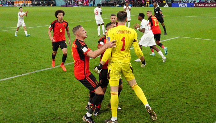 Belgiums Thibaut Courtois celebrates with teammates after saving a penalty missed by Canadas Alphonso. Reuters