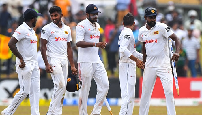 Sri Lankas Prabath Jayasuriya (R) celebrates with teammates after Sri Lanka won by 246 runs at the end of the second cricket Test match between Sri Lanka and Pakistan at the Galle International Cricket Stadium in Galle on July 28, 2022. — AFP