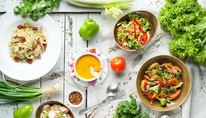 A kitchen table with different vegan dishes.— Unsplash
