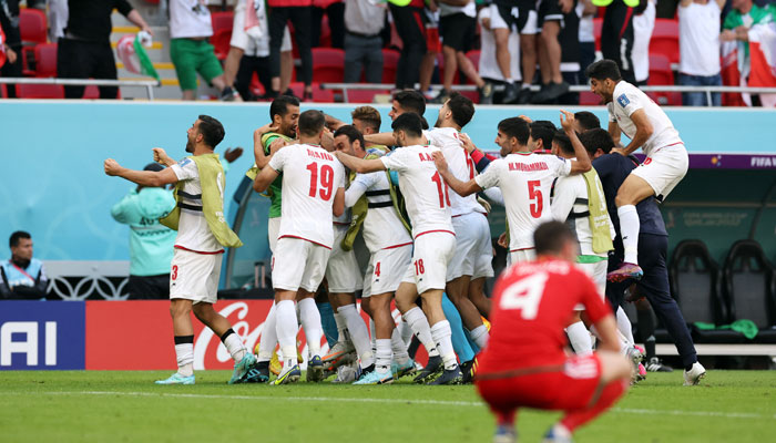 Irans Roozbeh Cheshmi celebrates scoring their first goal with teammates. — Reuters