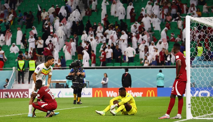 Qatars Meshaal Barsham, Almoez Ali and Mohammed Muntari look dejected after the match. — Reuters