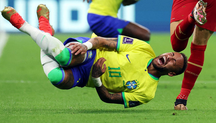 Brazils Neymar reacts after a challenge from Serbiaa Sasa Lukic. — Reuters