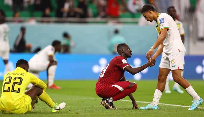 Senegals Iliman Ndiaye shakes hands with Qatars Almoez Ali after the match onNovember 25, 2022. — Reuters