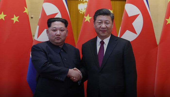 North Korean leader Kim Jong Un and Chinese President Xi Jinping shake hands at the Great Hall of the People in Beijing, China, in this picture released to Reuters on March 28, 2018. — Reuters