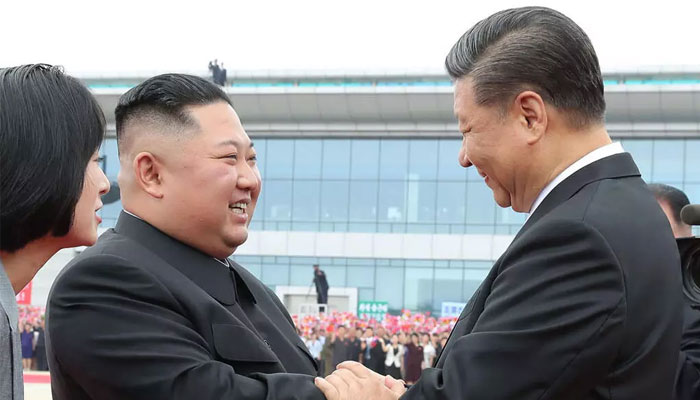 Xi Jinping (right) and Kim Jong Un (right) in Pyongyang in 2019. — AFP/File