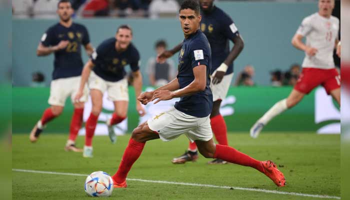 France’s defender #04 Raphael Varane looks at the ball during the Qatar 2022 World Cup Group D football match between France and Denmark at Stadium 974 in Doha on November 26, 2022. — AFP